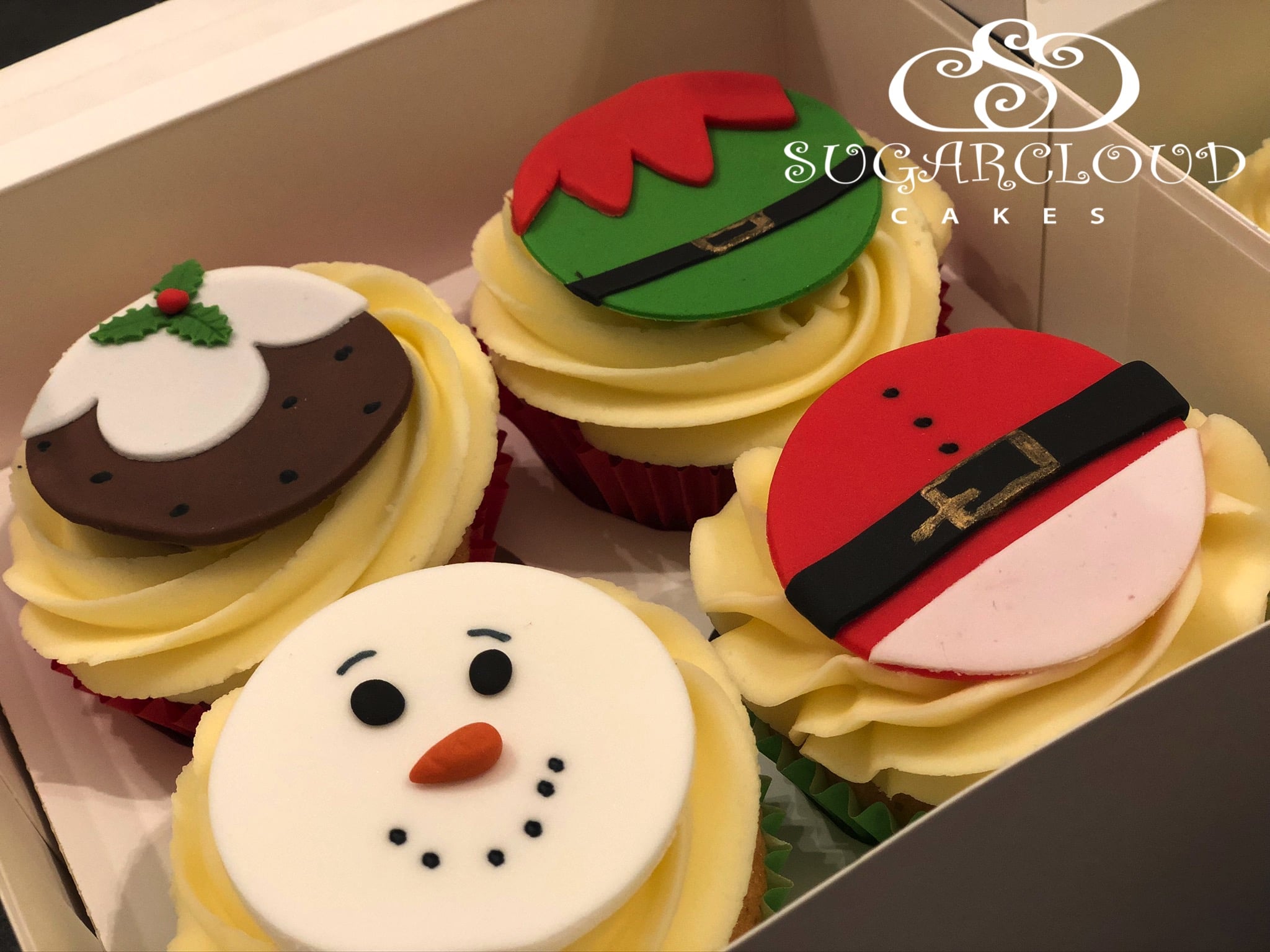 Vanilla cupcakes topped with Christmas Themed Toppers, Crewe